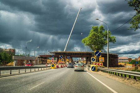 Moscow, Russia - June 5, 2015. under construction overpass over Leningrad Highway against stormy skyのeditorial素材