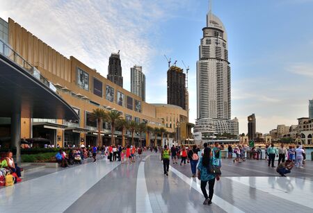 Dubai, UAE - April 8. 2018. Tourists on square at fountain in front of Dubai Mall.のeditorial素材