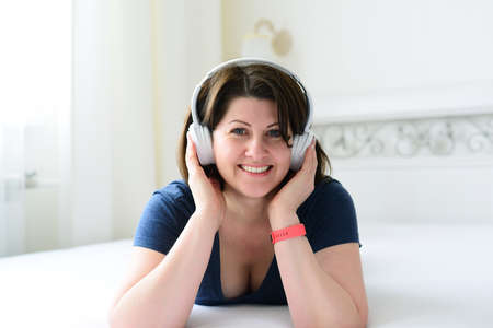 Portrait of a woman with wireless headphones.の写真素材