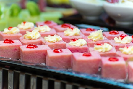 a lot of fruit cakes on a buffetの写真素材