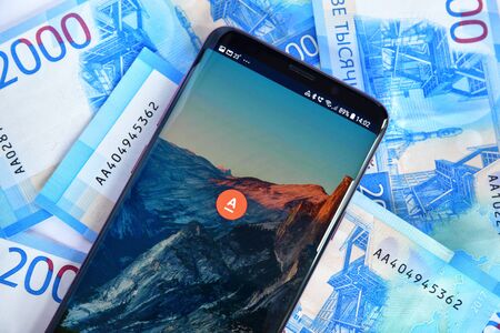 Moscow, Russia - July 23. 2018. The phone with mobile application Alfa-Bank online and money.