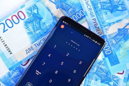 Moscow, Russia - July 23. 2018. The phone with mobile application Alfa-Bank online and money.