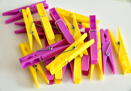 yellow and pink linen clothespins on a light backgroundの写真素材