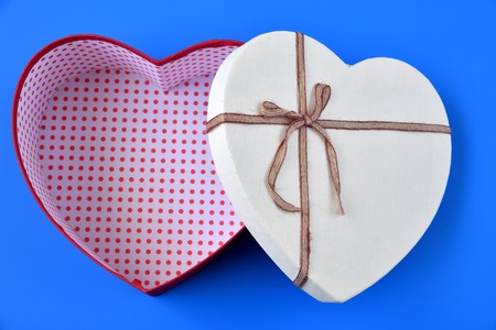 box for gifts in the shape of a heart on a blue backgroundの写真素材
