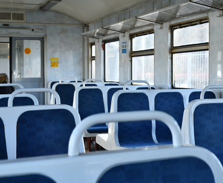 Old blue plastic seats in a suburban train in Moscow, Russia