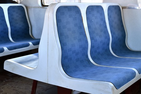 Old blue plastic seats in a suburban train in Moscow, Russia
