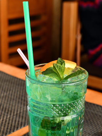 Glass with non-alcoholic mojito in a restaurantの写真素材