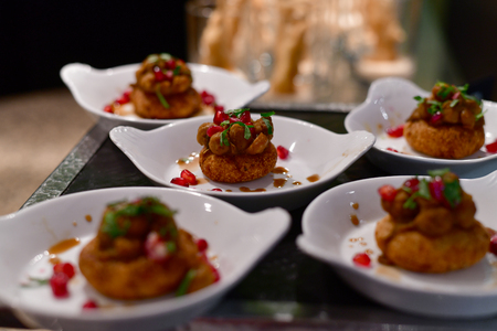A Portion of potato snack with pomegranate
