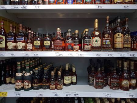 Moscow, Russia - January 21. 2019. Different types of cognac on counter of Pyaterochka storeのeditorial素材