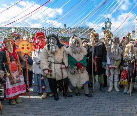 Moscow, Russia - March 9. 2019. Masked men during celebration of Shrovetide on Manezh Squareのeditorial素材