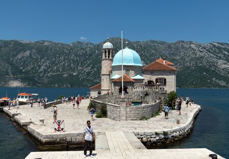 Perast, Montenegro - June 10. 2019: Church of Our Lady of the Rocks on artificial island of Gospa od...