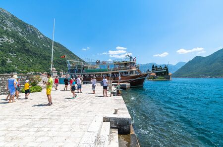 Perast, Montenegro - June 10. 2019: Tourists on artificial island of Gospa od Skrpjela.