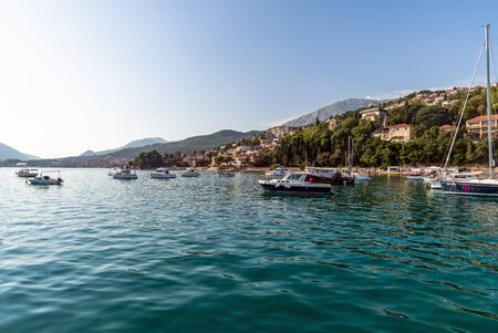 Herceg Novi, Montenegro - June 10. 2019. Yachts in port on the background of the city