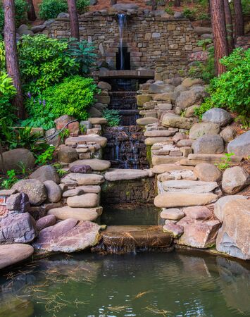 Cascading fountain with a stones in landscape designの写真素材