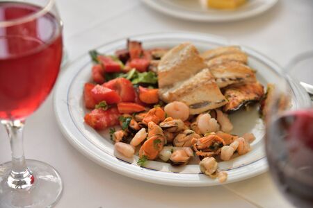 Fish and mussels on a plate in a restaurantの写真素材