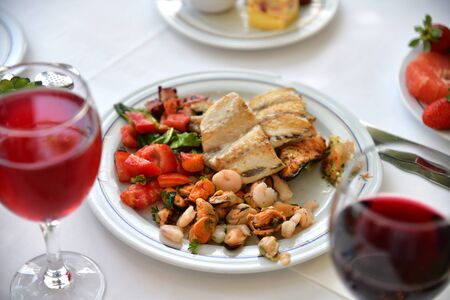 Fish and mussels on a plate in a restaurantの写真素材