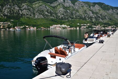 Kotor, Montenegro - 10. 6. 2019. Different ships on the quay near the embankment
