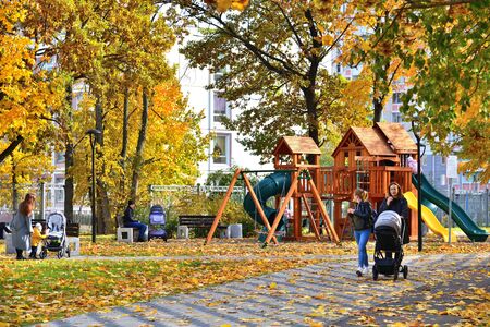 Moscow, Russia - October 3. 2019. Moms with children in playground in the autumn parkのeditorial素材