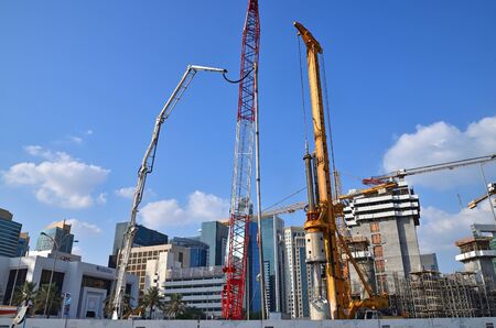 Doha, Qatar - Nov 29. 2019. Different construction equipment against background of downtown skyscrapersのeditorial素材