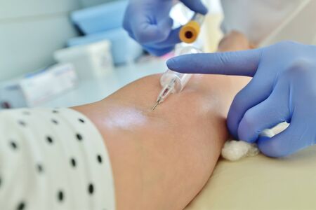 Doctor takes blood from vein for analysis