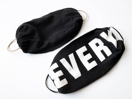 Black mask made by hand during a pandemic Covid-19 due to lack of industrial masks in pharmaciesの写真素材