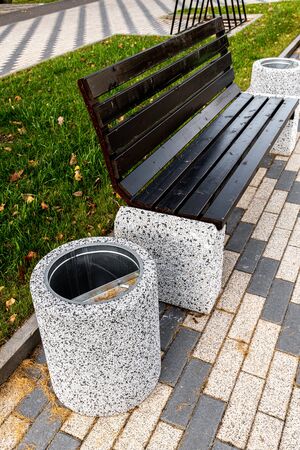 Trash can near the wooden benchの写真素材