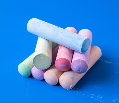 Childrens colored crayons for drawing on blue backgroundの写真素材