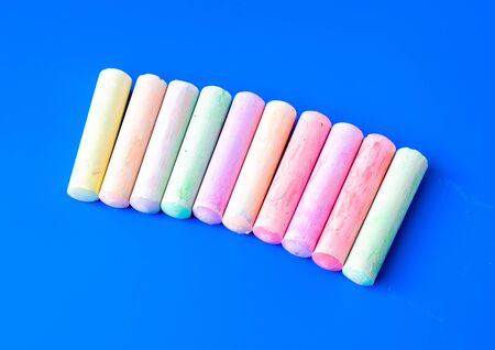 Childrens colored crayons for drawing on blue backgroundの写真素材