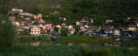 A small village on a hill near a lake in Montenegroの写真素材