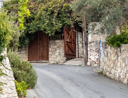Narrow street in a tourist ancient village of Lania, Cyprusの写真素材