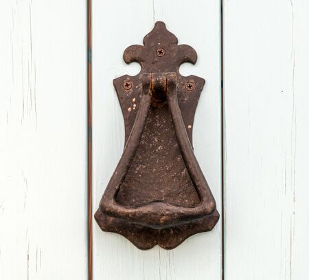 Antique doorknob on a white doorの写真素材