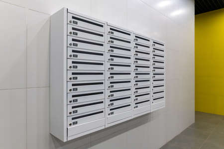 Mailboxes on wall in an apartment buildingの写真素材