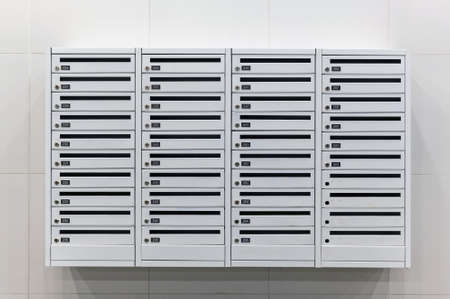 Mailboxes on wall in an apartment buildingの写真素材