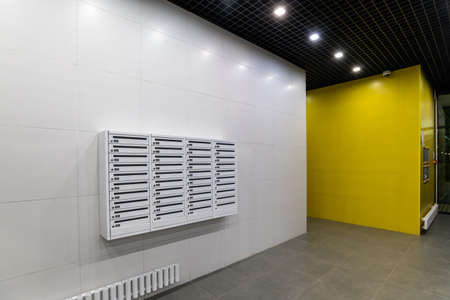 Mailboxes on wall in an apartment buildingの写真素材
