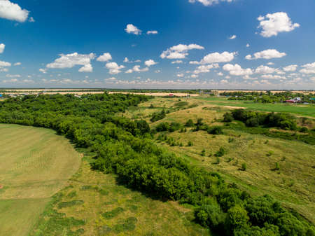 Top view of rural houses surrounded by fields in central Russiaの写真素材