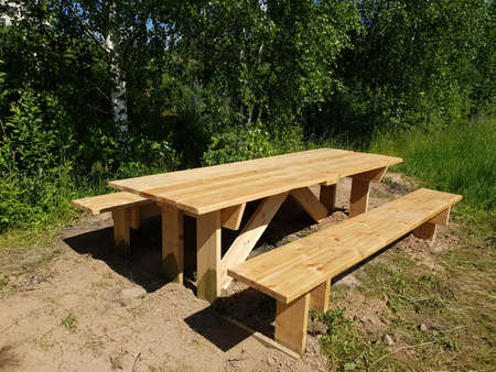 Wooden table and benches for outdoor recreationの写真素材