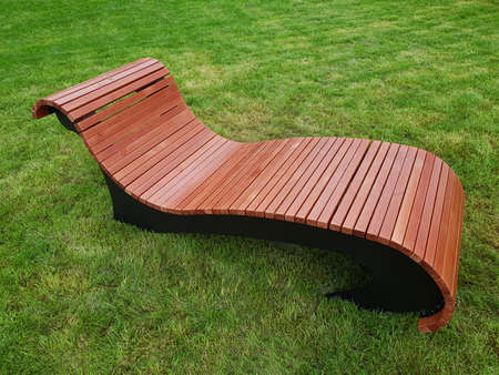 Wooden lounger for rest in city park in Moscow, Russiaの写真素材