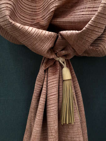 Fragment of beautiful brown curtains with holderの写真素材
