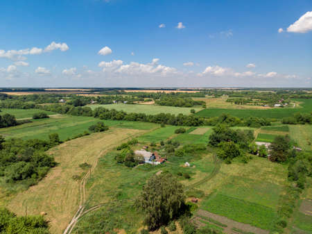 Top view of rural houses surrounded by fields in central Russiaの写真素材