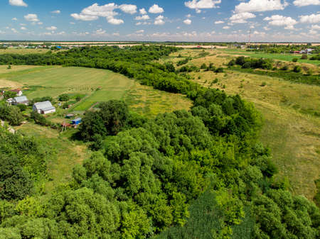 Top view of rural houses surrounded by fields in central Russiaの写真素材