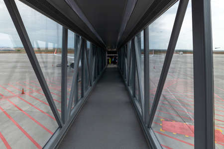Simferopol, Crimea -July 11. 2019. Telescopic ladder for boarding the planein Simferopol international airportのeditorial素材