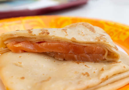 Pancake with salmon on a patterned plate. Pancake week food conceptの写真素材