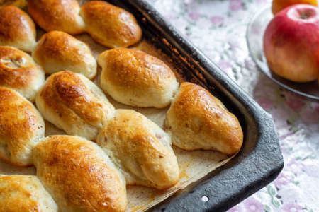 Baked homemade pies with apple on the baking sheetの写真素材