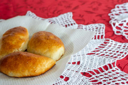 Baked homemade pies on a plate with a lace napkinの写真素材