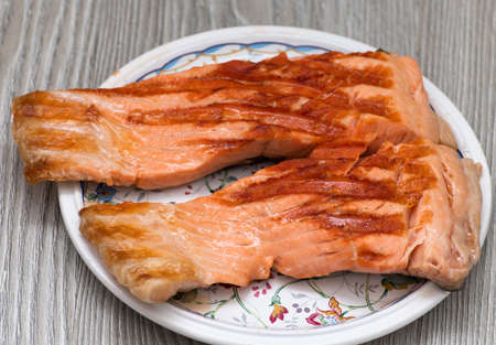 grilled trout steaks lie on a plate