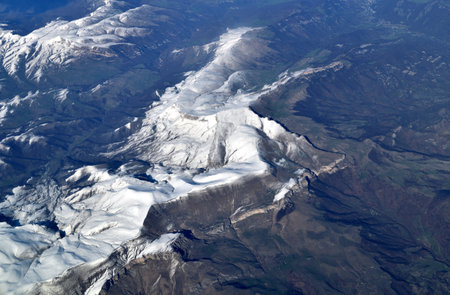 Top view of mountain peaks in the snowの写真素材