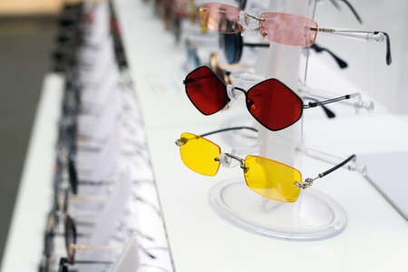 Sunglasses with colored lenses in shop window