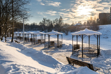 Row of metal gazebos on the bank of a frozen pond, Russiaの写真素材