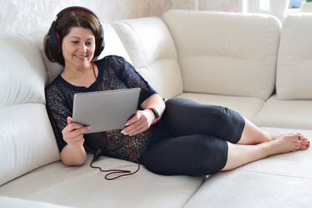 woman working on tablet and a wearing headphonesの写真素材