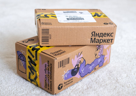 Moscow, Russia - 06 March 2022. Yandex Market online trading package standing on the floor in room
